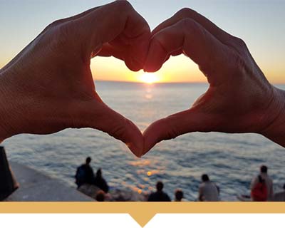 Photo of hands forming the shape of a heart.